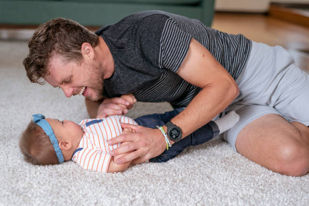 istock Handsome father playing with his baby daughter at home 1283414834