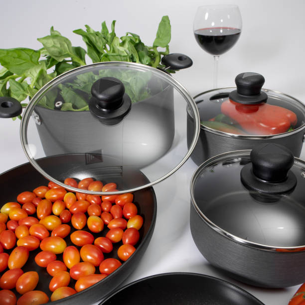 istock kitchenware - Set of non-stick pots with glass lids; photo on white background. 1283415525