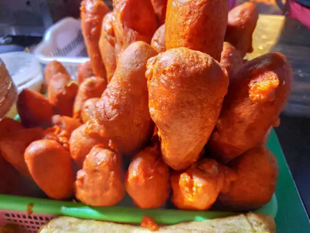 Soyabean chaap rolled in besan for deep fry swarved with chiily sauce a chinese snack made in streets of indian food stall.
