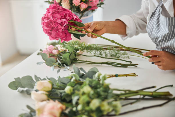 istock Hands of professional flower shop worker making a bouquet 1283416586