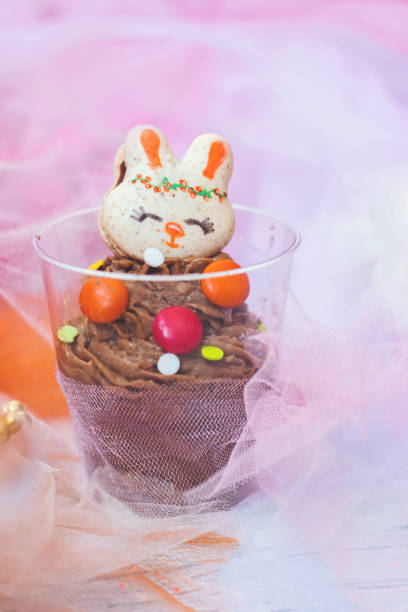 istock Chocolate mousse in transparent plastic cup, decorated with bunny shaped cookie 1283416784
