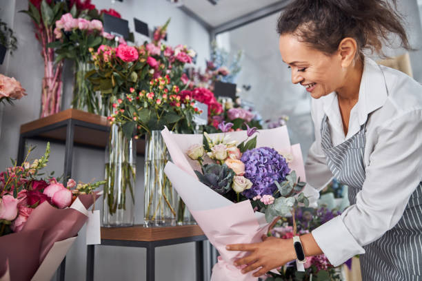 istock Professional florist carefully arranging bouquets on a display 1283418521