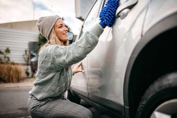 istock Women rubbing car with wipe cloth 1283418809