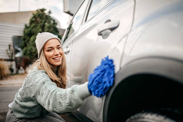 istock Women rubbing car with wipe cloth 1283419504