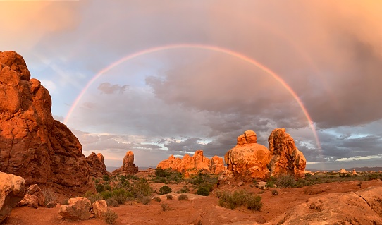 Buttes, spires and rainbow in Arches National Park in Utah.