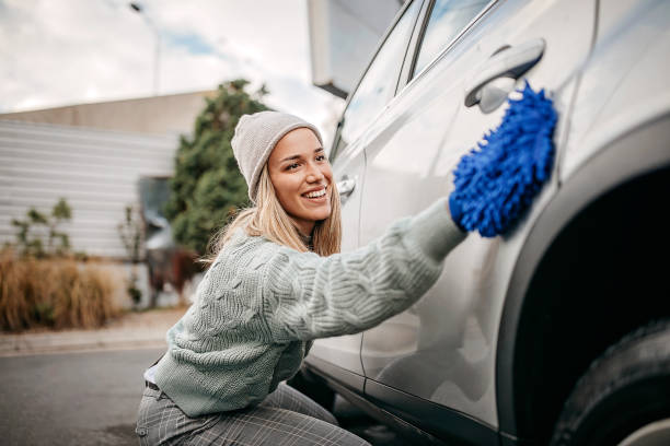 le donne sfregano l'auto con un panno per la pulizia - wash stand foto e immagini stock