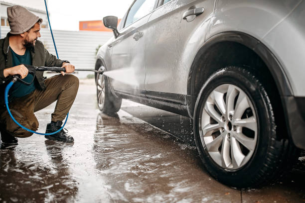 istock Men washing car at fuel pump by himself 1283419887