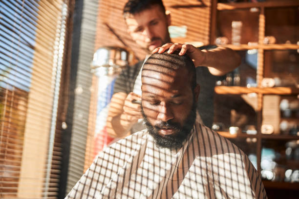 istock Barber applying talcum powder on client neck 1283421551