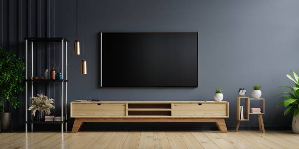 LED TV on the dark wall in living room. LED TV on the dark wall in living room with wooden cabinet,minimal design,3d rendering television set stock pictures, royalty-free photos & images