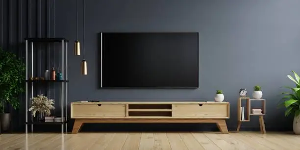 LED TV on the dark wall in living room with wooden cabinet,minimal design,3d rendering