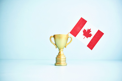 Gold Trophy with Canadian Flag on Blue Background