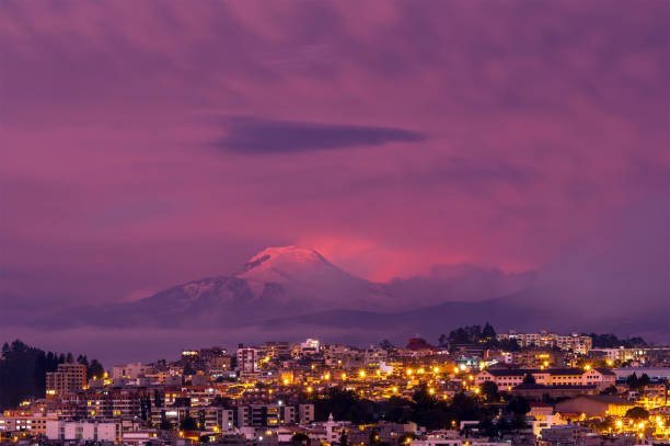 Quito Sunset, Ecuador Purple sunset in Quito city with Cayambe volcano in the background, Ecuador. cuenca ecuador stock pictures, royalty-free photos & images