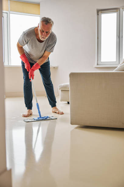 istock Responsible elderly man cleaing his floor with a mop 1283435319