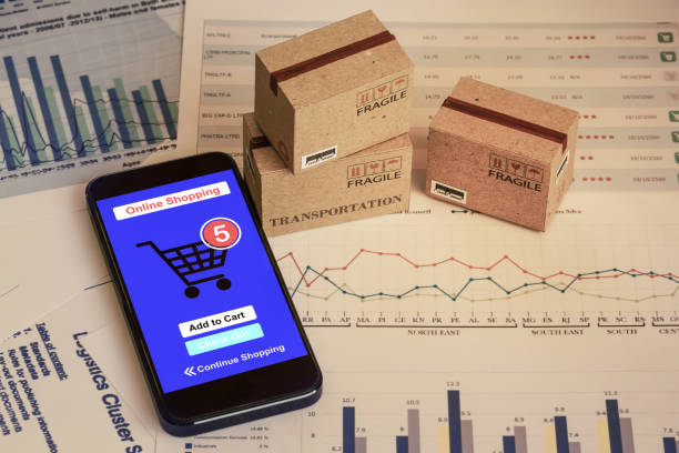 istock Smartphone runs an online shopping app with cardboard boxes. concept about this type of financial charts include stacks of bar compare between the expansion of export business for goods each year. 1283436040