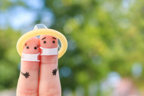 fingers art of happy couple in medical mask from covid-2019. koncepcja bezpiecznego seksu. - hiv aids condom sex zdjęcia i obrazy z banku zdjęć