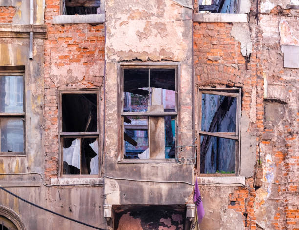 istock old brick building and broken windows in the wall 1283439748