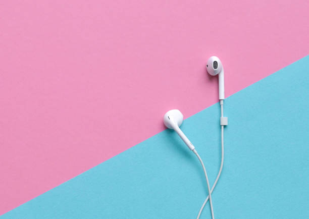 istock Ear phones on blue and pink background. Copy space. 1283439867
