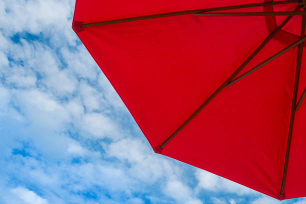 istock Red umbrella with blue sky and bright atmosphere 1283440605