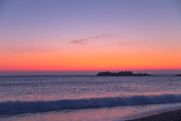 istock Beautiful orange purple sunset on the beach 1283440627