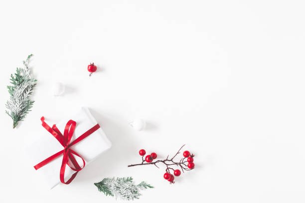 istock Christmas composition. Frame made of gift, snowflakes, fir tree branches and red berries on white background. Christmas, winter, new year concept. Flat lay, top view 1283451180