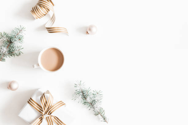 Christmas composition. Gift, fir tree branches, plaid, cup of coffee, balls on white background. Christmas, winter, new year concept. Flat lay, top view