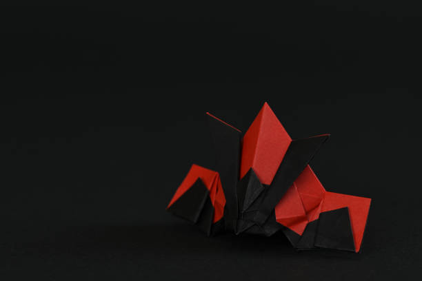 istock Origami helmet on black background. 1283451245