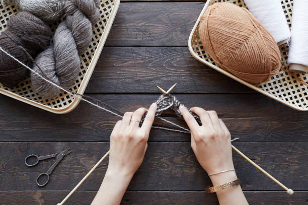 istock Girl knitting at the table 1283454408