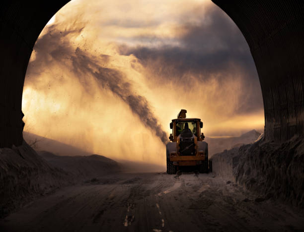 Snow removal machine leaving the tunnel during golden hour in Senja, Norway. Snow blower cleaning the snow and leaving the tunnel during golden hour in Senja, Norway. senja island photos stock pictures, royalty-free photos & images