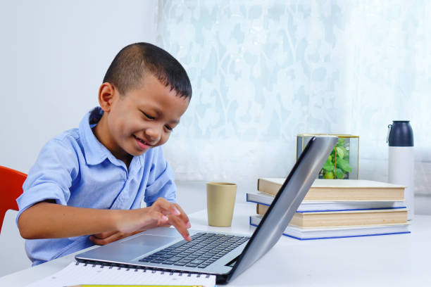 istock A boy learning alone with laptop at home. Distance learning concept. 1283455844