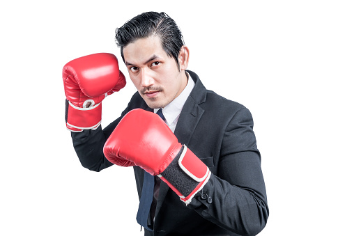 Asian businessman with red boxing gloves fighting isolated over white background
