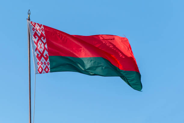 istock Flag of Belarus waving against blue sky 1283457778