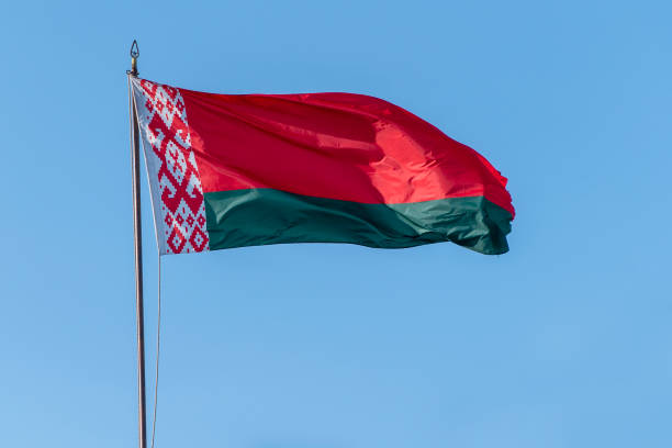istock Flag of Belarus waving against blue sky 1283457780