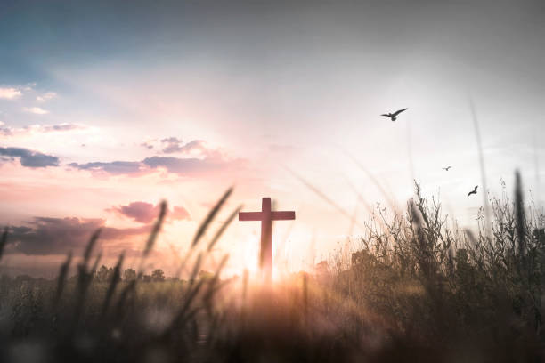 istock Easter concept: Silhouette cross on mountain at sunset background 1283459054