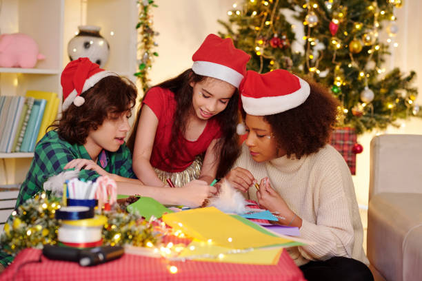 istock Children creating Christmas poster 1283460037