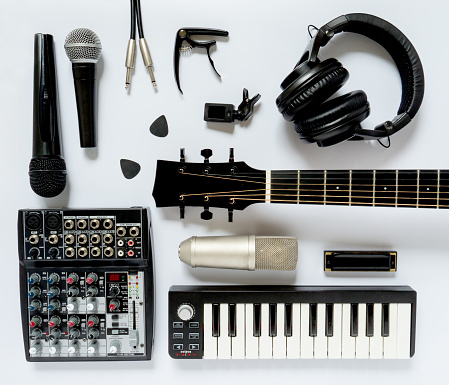 Black and white flat lay composition. Portable and compact music home studio for music production. Top view on professional audio devices.