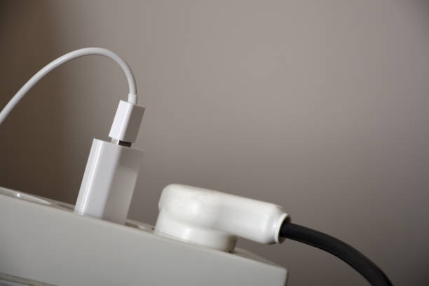 istock Electrical outlet, electrical plug, extension cord with wall background 1283460847