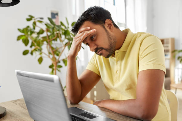 istock indian man with laptop working at home office 1283461091