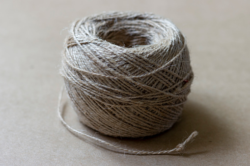 A coil of jute rope used for needlework and handicrafts.