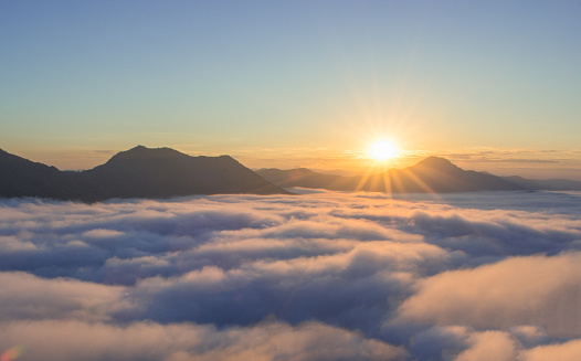 beautiful sunrise over mountain with fog in the morning