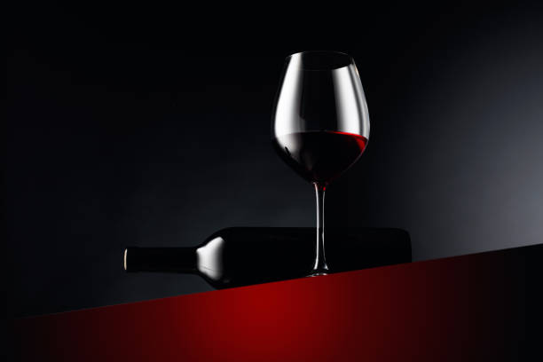 istock Glass and bottle of red wine on a dark background. 1283464005