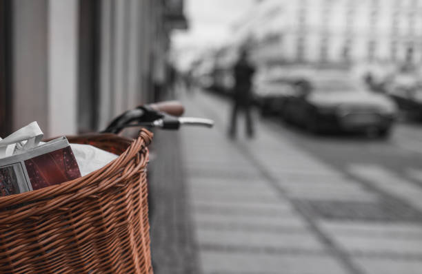 Newspaper in a bicycle basket parked by a old tenemet house wall in Świebodzice, Poland