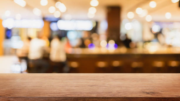 istock Empty wood table top and blurred coffee shop and restaurant interior background - can used for display or montage your products. 1283465676