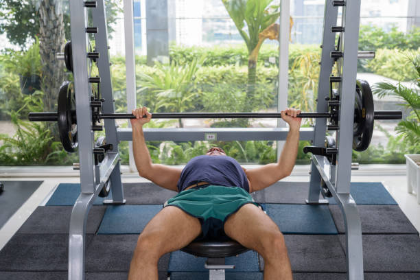 istock Mature handsome Persian man doing bench press at the gym 1283467426