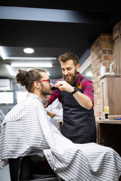 istock Client during beard and moustache grooming in barber shop 1283467648
