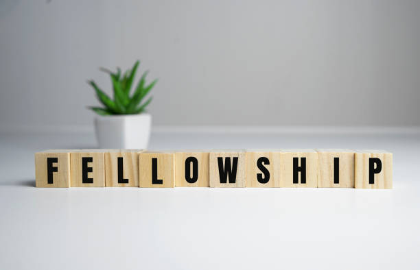 istock Fellowship concept - Fellowship word on wooden cubes 1283469809