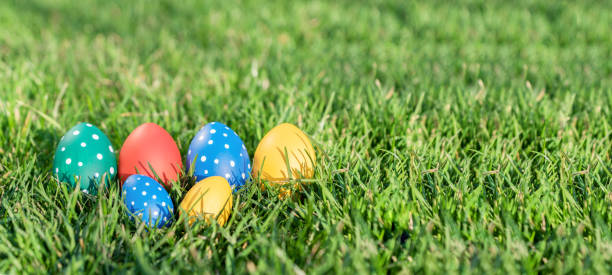 istock six bright easter eggs of different colors lie in green grass, hidden eggs, celebration of easter, 1283470256