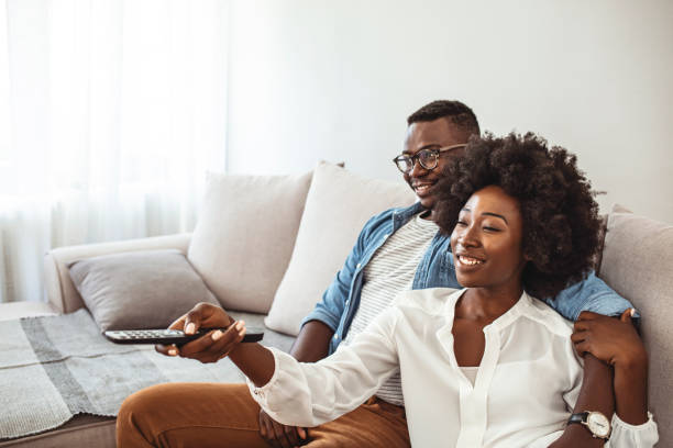 istock Happy couple watching tv 1283472799