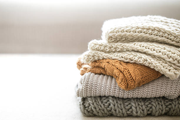 istock A stack of neatly folded warm knitwear, wool close up. 1283472854