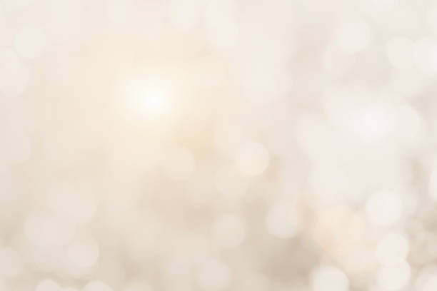 istock Cream blurred christmas lights background. Design effect focus happy holiday party glow texture white wallpaper bokeh sun sunny star shiny soft plain warm flare blur night light new year. 1283473548