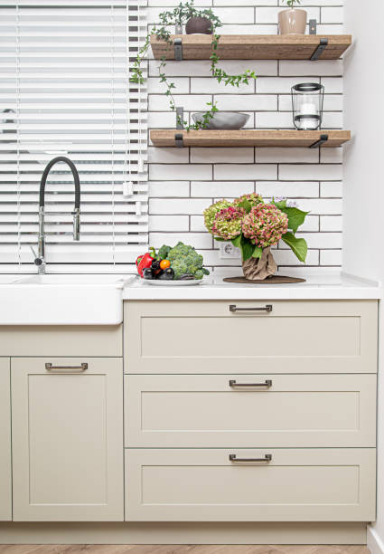 istock Kitchen interior near the wash basin with white cabinets in a minimal style. 1283474289